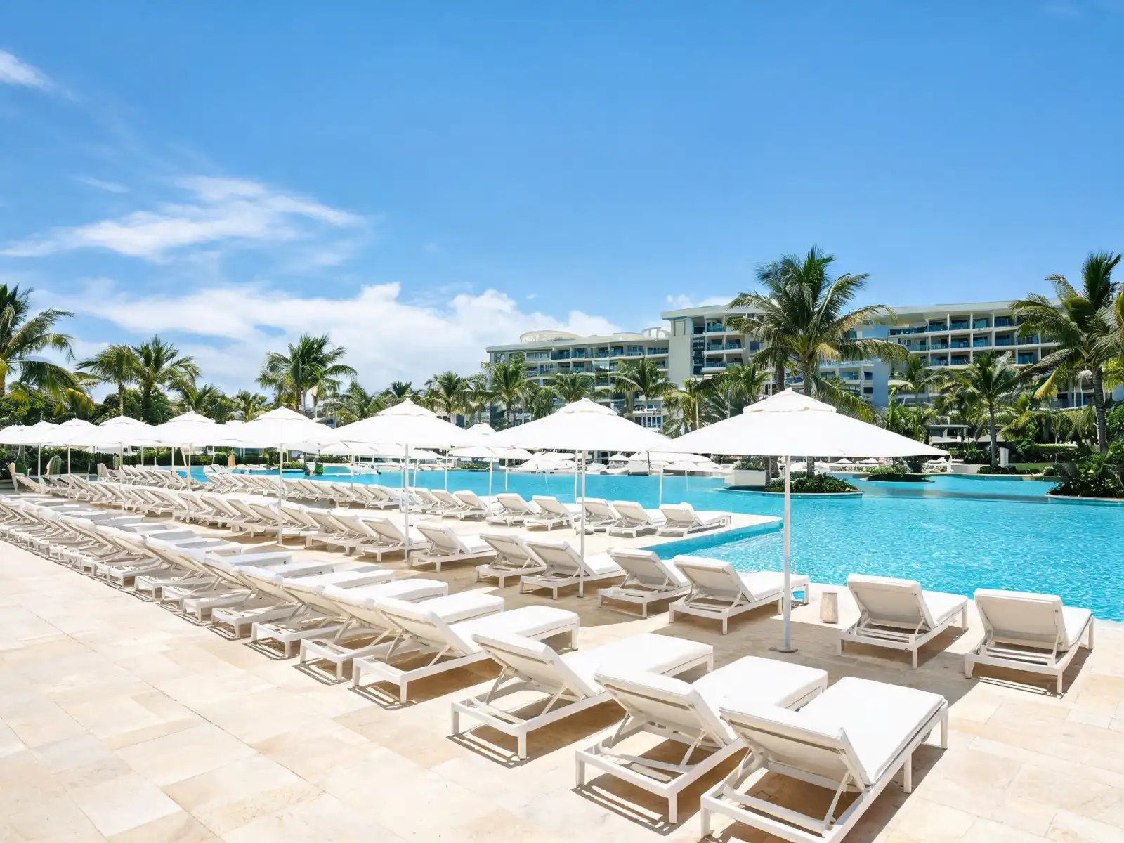 Resort pool deck with reclining outdoor lounge furniture