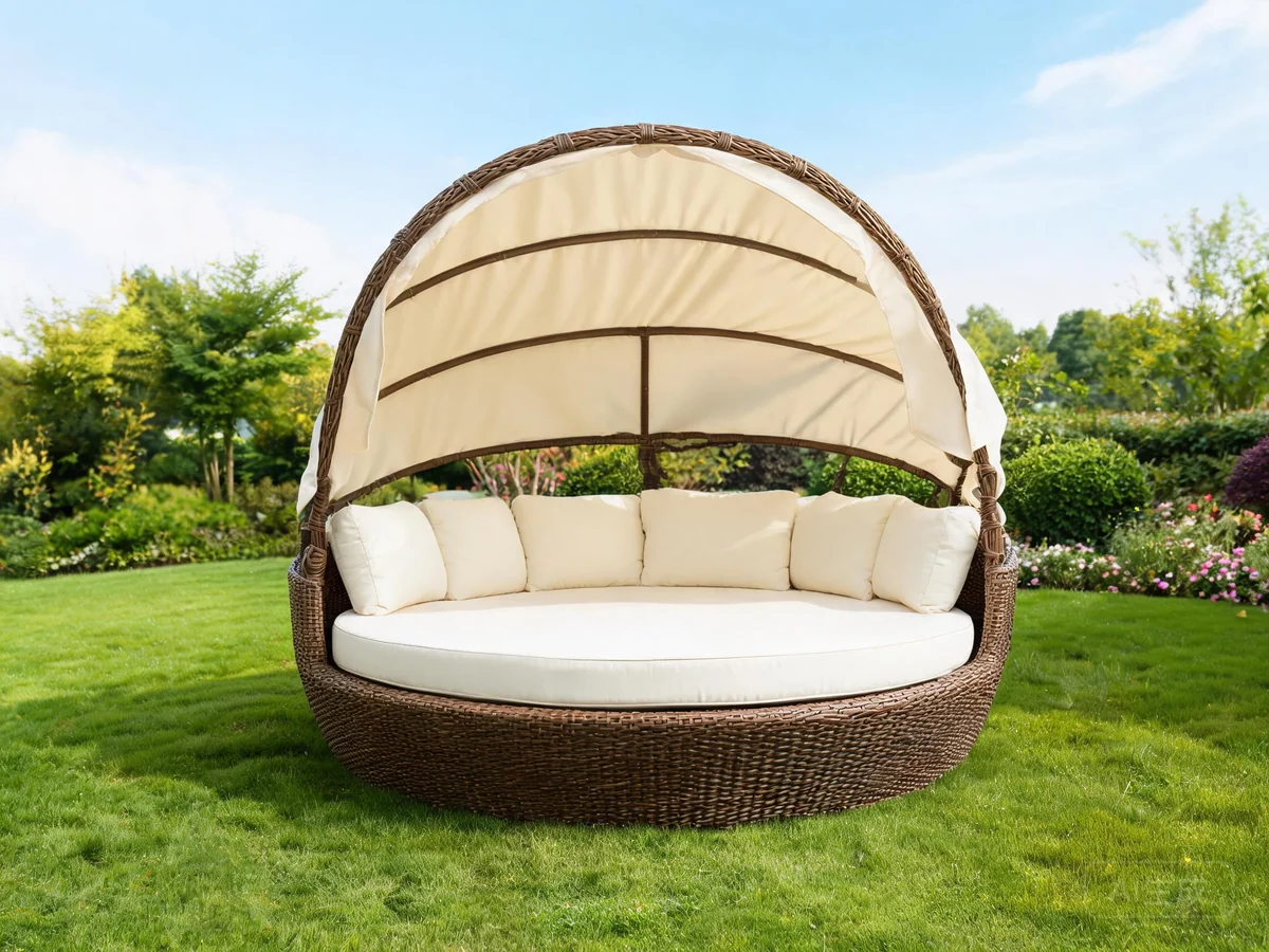 Round outdoor rattan daybed with canopy and plush cushions