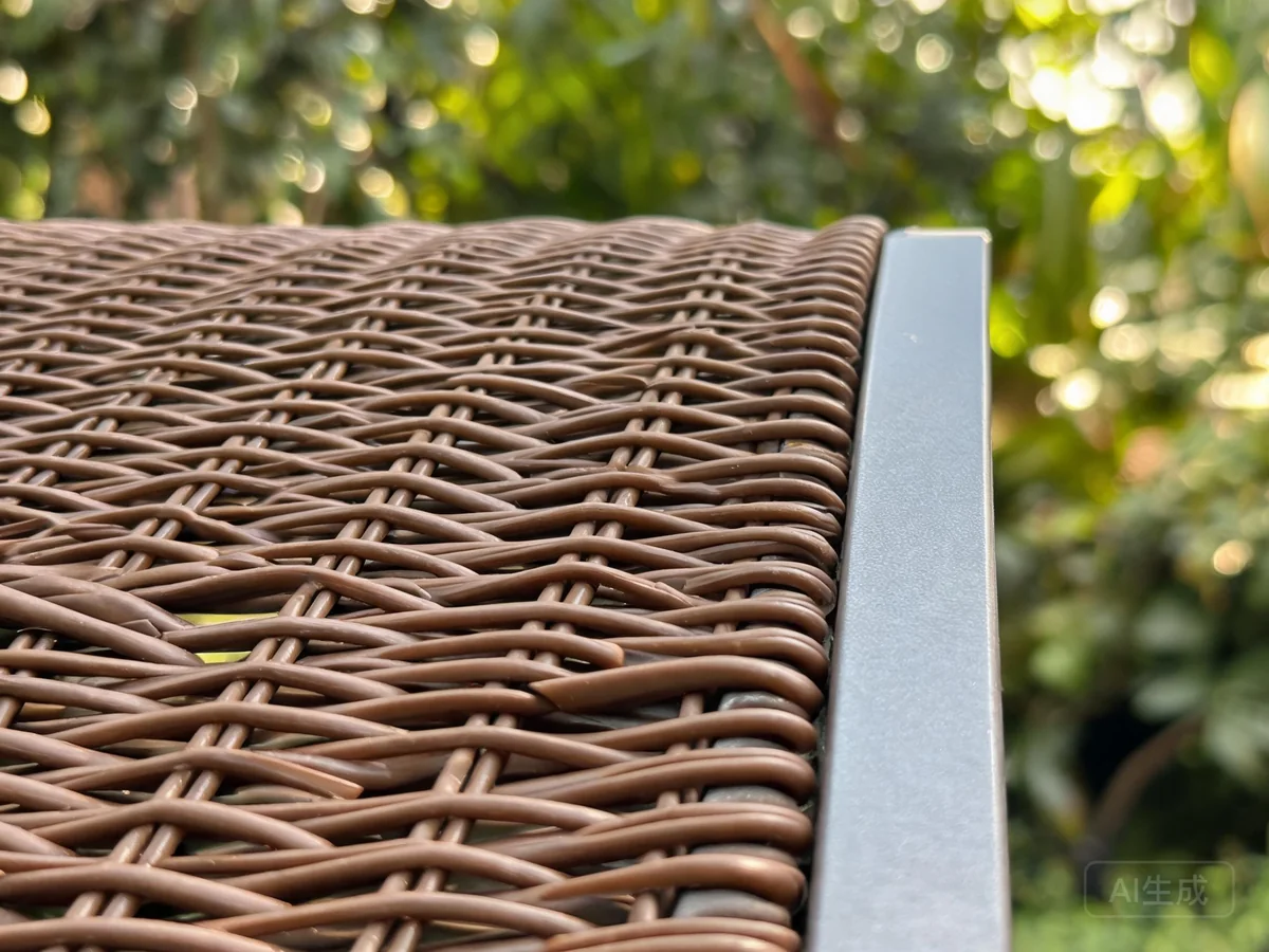 Close-up of brown PE rattan flat weave over aluminum frame